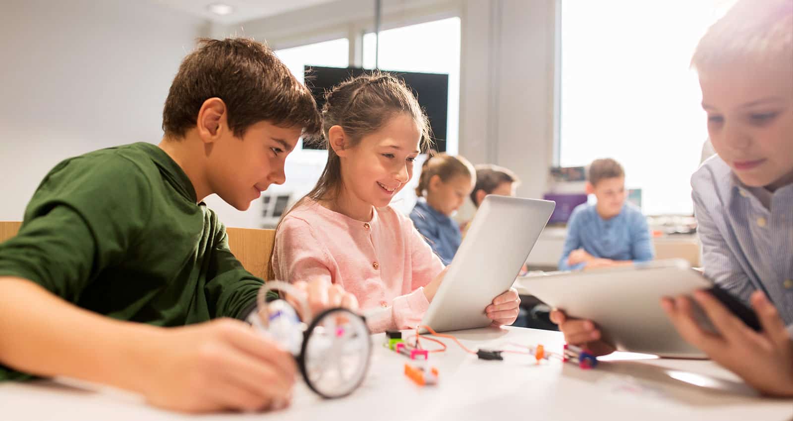 The-Works-Sylvan-Learning-header Children in a classroom engaged in learning look at computers.